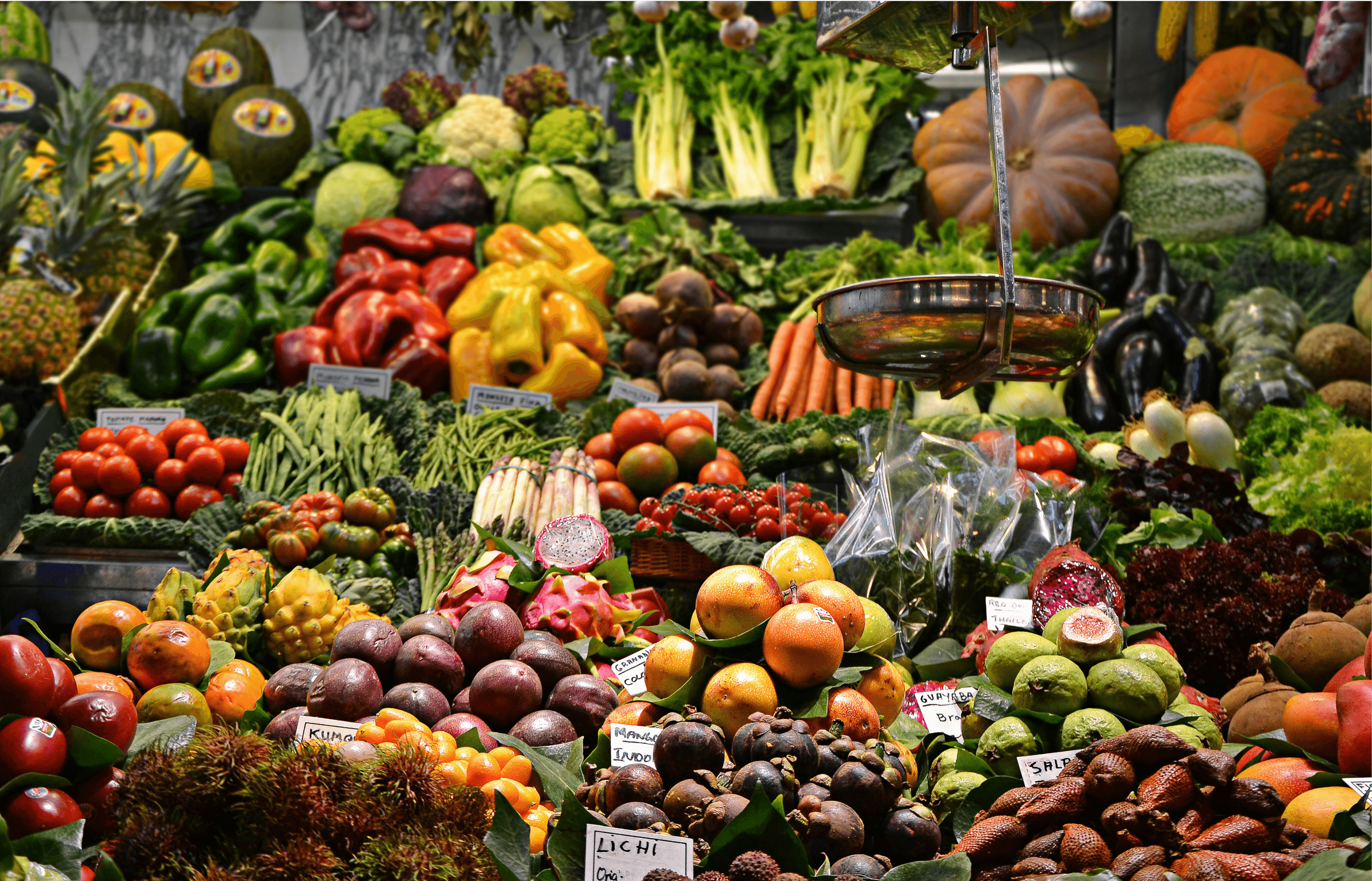Background image of crates filled with colorful, fresh fruit at a lively market, showcasing natural abundance.